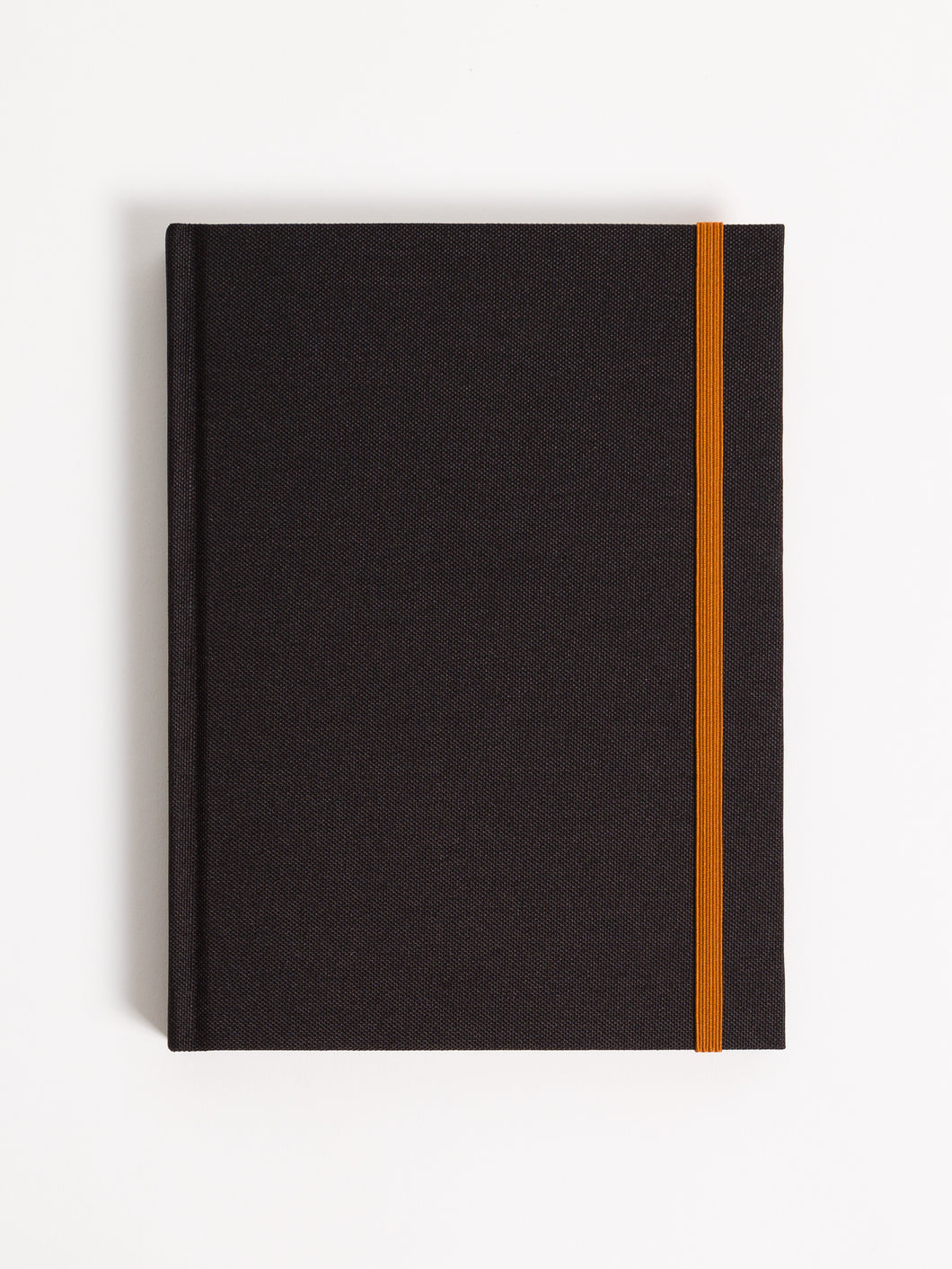 closed black journal with 5 tabs and a terracotta elastic band